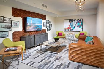 Resident lounge with billiards table, shuffleboard, card room, demonstration kitchen, and more